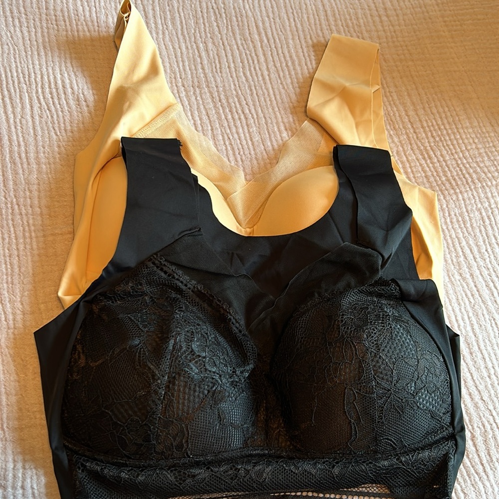 Two brand new bras size 34D. One black lace and one cream bra. No underwire.
